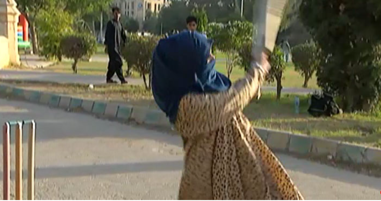 A veiled woman in a burqa skillfully playing cricket in Karachi, gaining viral attention across social media platforms