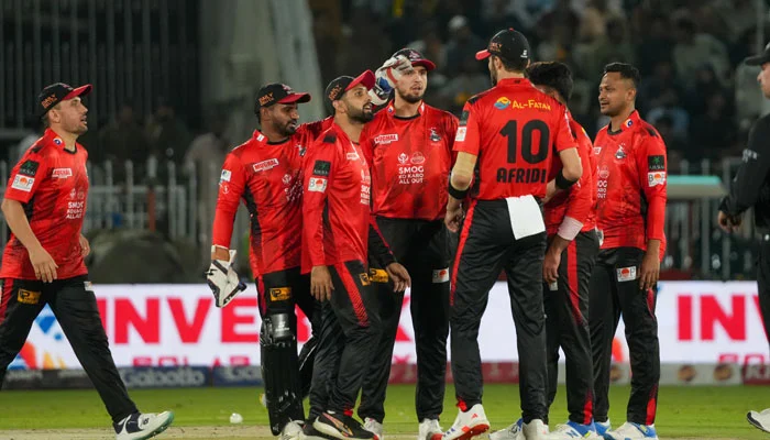 Crowd at Gaddafi Stadium in Lahore cheering during PSL 10 playoffs match under stadium lights