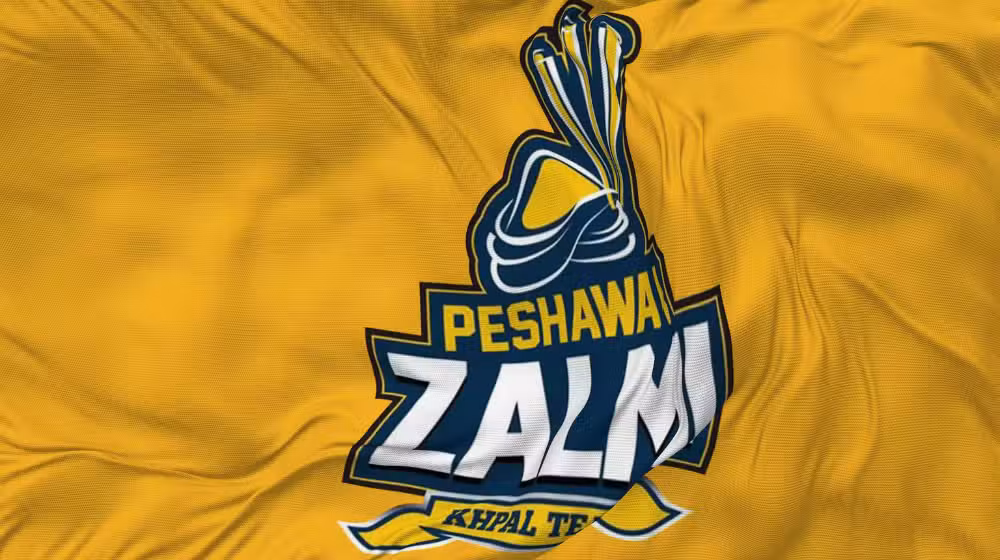 A Peshawar Zalmi cricketer walking away from the team with an IPL logo in the background.